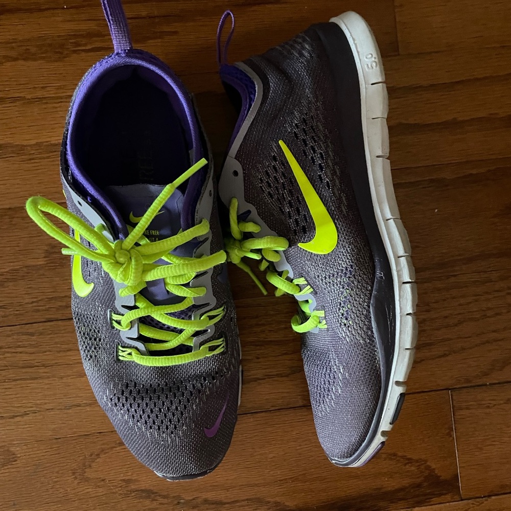 Women’s size 7 Nikes. Purple with highlighter shoe strings. Like new condition